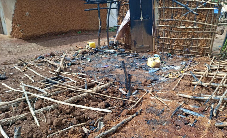 A house reduced to a black square of ashes and burned earth